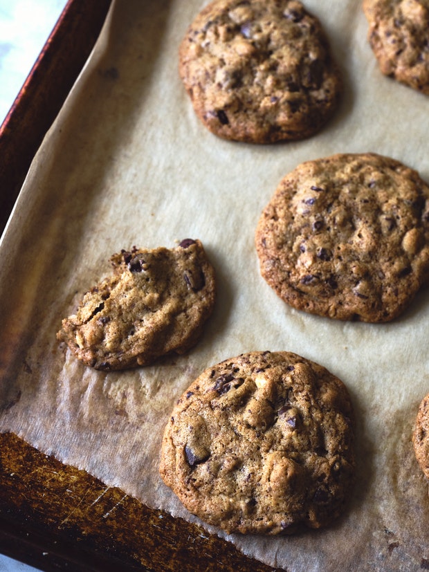 Chocolate Chip Cookies on a parchment-lined baking sheet”   border=