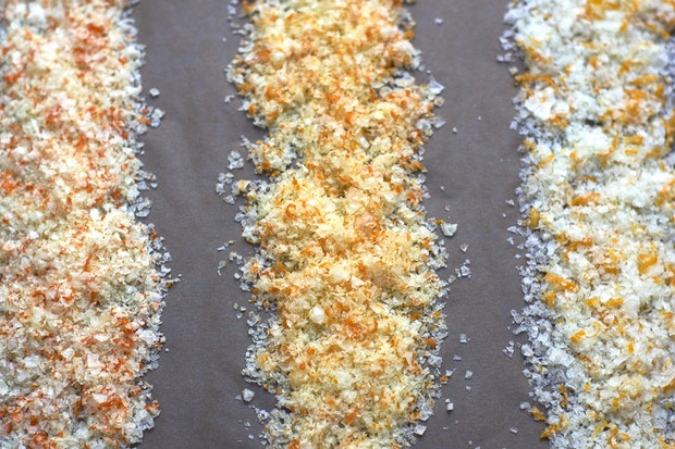 three different examples of citrus salt drying on baking sheet