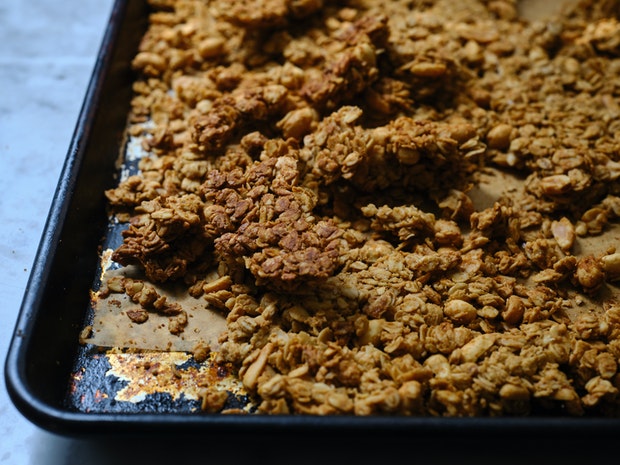 peanut butter granola cooling on a baking sheet