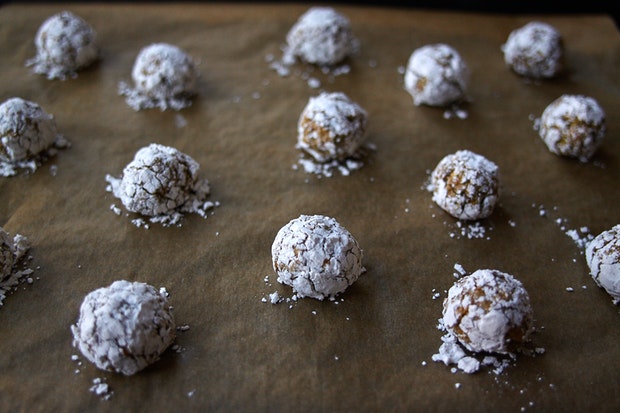 small balls of cookie dough arranged on a parchment-lined baking sheet