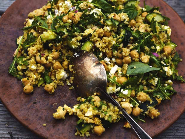 quinoa salad on a large plate with a serving spoon